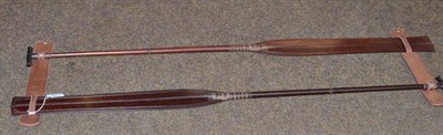 Lot 449 - A pair of 20th century Malaysian ceremonial oars, of dark red hardwood, each with spatula type...