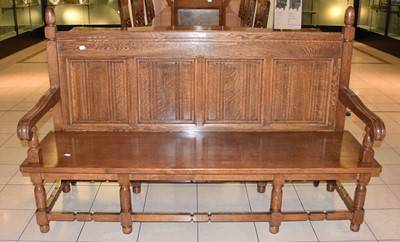 Lot 1162 - A Reproduction Four Panel Oak Settle, with...