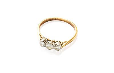 Lot 150 - A Diamond Three Stone Ring, the graduated...