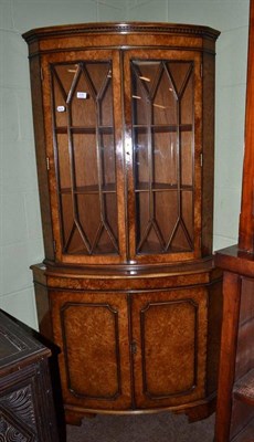 Lot 538 - A figured walnut bowfront standing corner cupboard