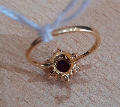 Lot 2107 - An 18 Carat Gold Ruby and Diamond Cluster Ring...