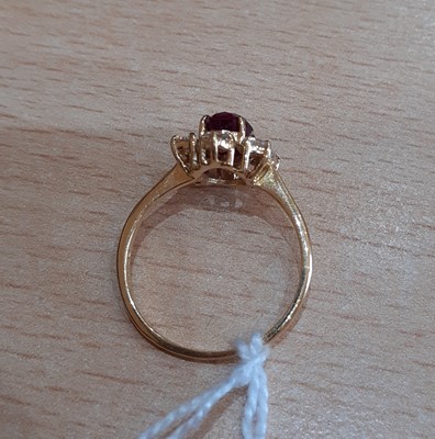 Lot 2107 - An 18 Carat Gold Ruby and Diamond Cluster Ring...
