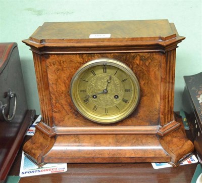 Lot 553 - A burr walnut veneered striking mantel clock