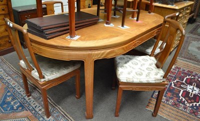 Lot 554 - An Oriental style extending dining table with a side table which forms and extra leaf together with