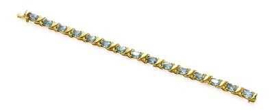 Lot 170 - A 14 Carat Gold Blue Topaz Bracelet, length 17....