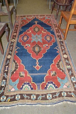 Lot 592 - An East Anatolian rug, the plain indigo field centred by a stepped medallion framed by...