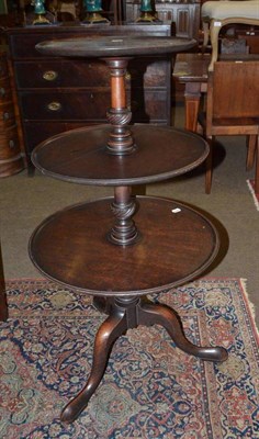 Lot 609 - A Georgian mahogany three tier dumb waiter with rolled leather casters