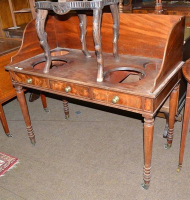 Lot 628 - A Georgian mahogany washstand with pierced gallery top