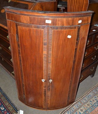 Lot 636 - A 19th century mahogany bow front corner cupboard