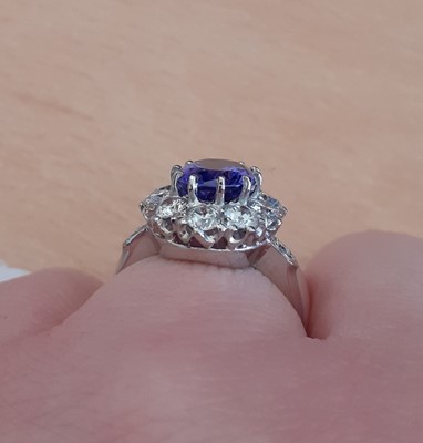 Lot 2018 - A Tanzanite and Diamond Cluster Ring the oval...