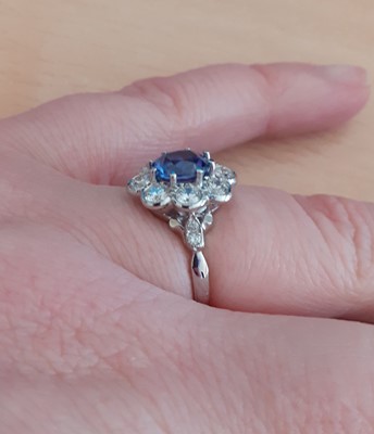 Lot 2017 - A Sapphire and Diamond Cluster Ring the round...