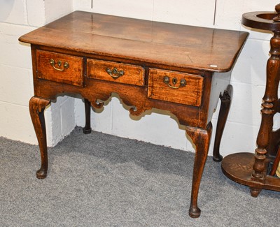 Lot 1318 - A George II Oak Three Drawer Lowboy, with...