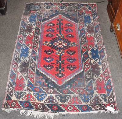 Lot 1103 - A Dosemealti Rug, the crimson lozenged field...