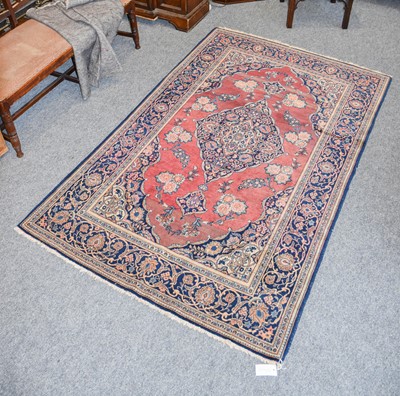 Lot 1110 - A Kashan Rug, the faded terracotta field...