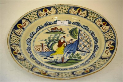 Lot 69 - An English Delft Dish, circa 1750, painted in blue, green, yellow and ochre with a kneeling...