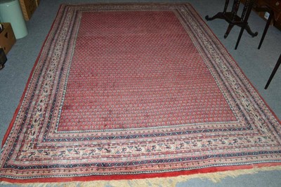 Lot 724 - A Mir/Serabend carpet, West Persia, the rust field of boteh enclosed by multiple borders, 288...