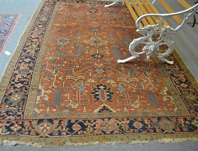 Lot 725 - A Heriz carpet, Persian Azerbaijan, the rust field of stylised leaves enclosed by indigo...