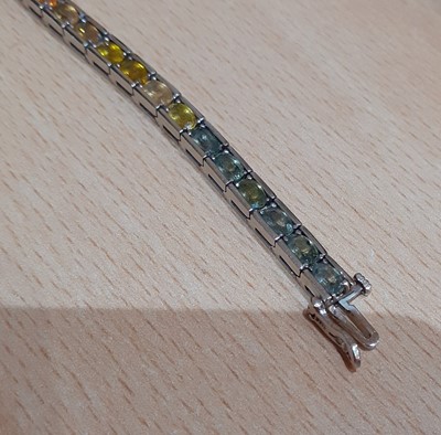 Lot 2086 - A Multi-Coloured Sapphire Line Bracelet formed...