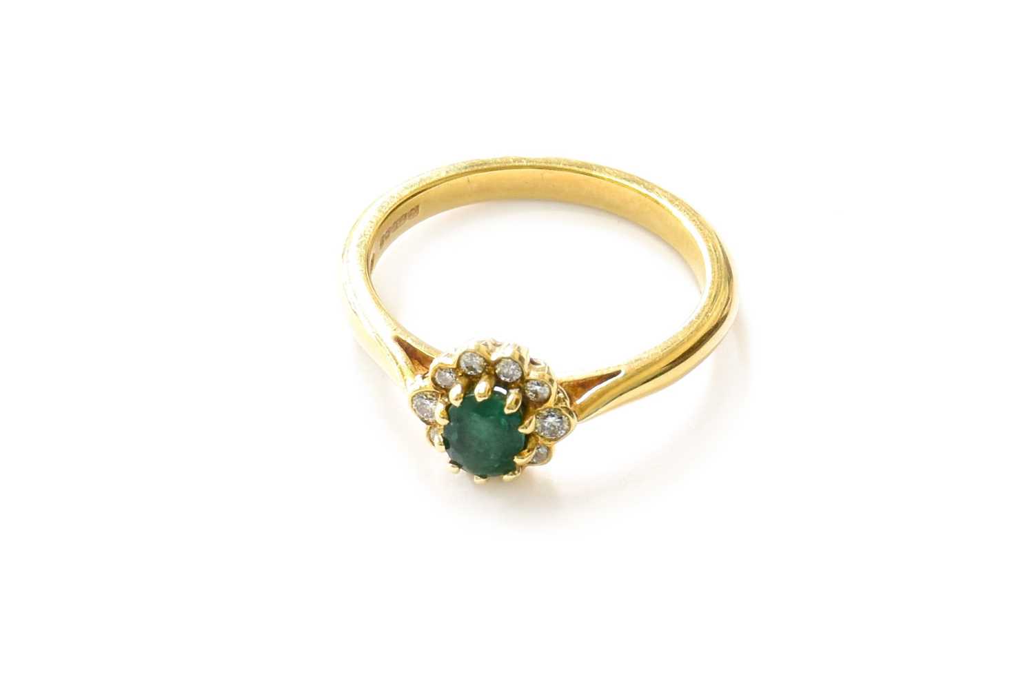 Lot 23 - An 18 Carat Gold Emerald and Diamond Cluster...