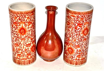 Lot 7 - Pair of iron red cylinder vases and bottle vase (3)