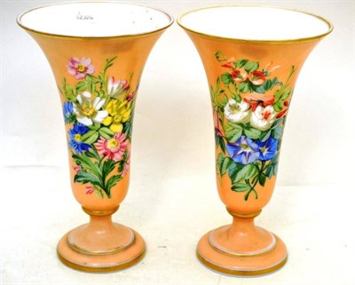 Lot 17 - Pair of Victorian glass peach ground flared pedestal vases painted with flowers
