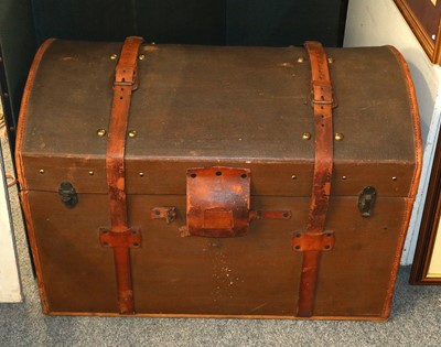 Lot 1255 - A canvas and leather domed top trunk with...