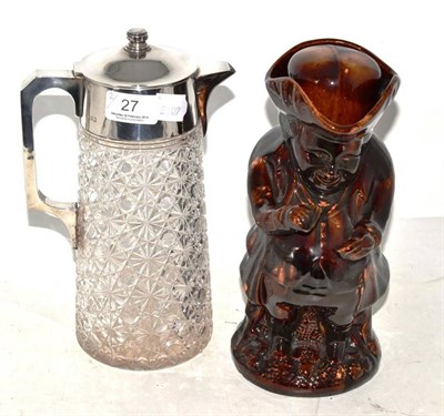 Lot 27 - A treacle glazed Toby jug and a silver mounted glass jug