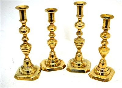 Lot 53 - Two pairs of brass candlesticks