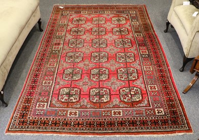 Lot 1101 - Khotan Rug, the field with three rows of guls,...