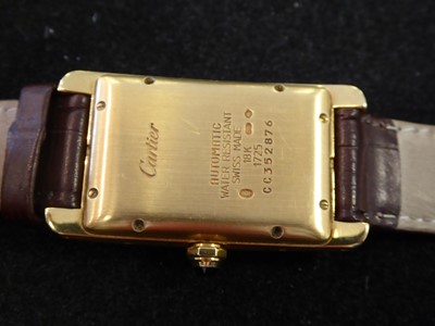 Lot 2245 - Cartier: An 18 Carat Gold Automatic Calendar...