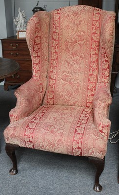 Lot 1420 - A Georgian Style Wing Back Armchair, the rear...