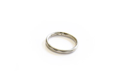 Lot 101 - A Band Ring, stamped 'PLATINUM', finger size H