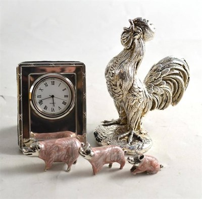 Lot 95 - Silver desk clock, silver filled cockerel and three silver graduated pigs with pink enamel...
