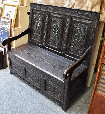 Lot 1252 - A 1920's Carved Oak Box Settle, decorated with...