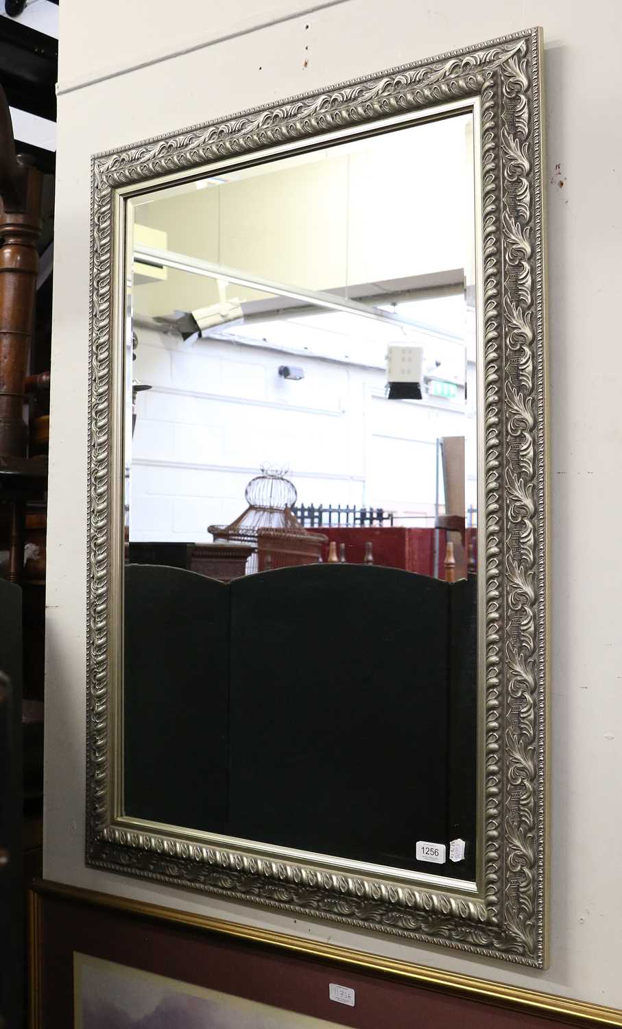 Lot 1256 - A modern mirror, the rectangular bevelled...