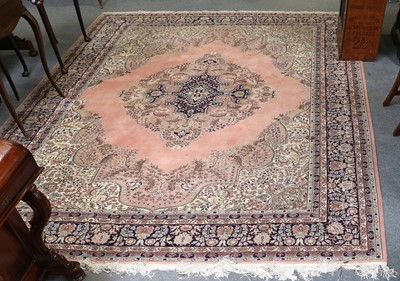 Lot 1275 - An Turkish Carpet, the salmon pink field with...