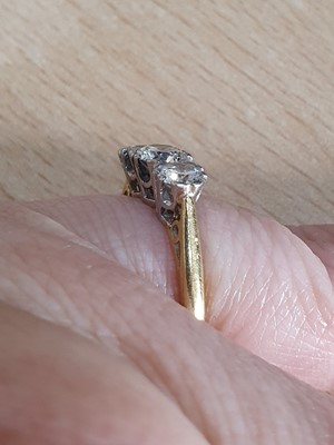 Lot 2077 - A Diamond Three Stone Ring the graduated round...