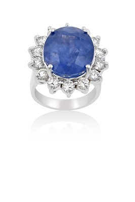 Lot 2098 - A Sapphire and Diamond Cluster Ring the oval...