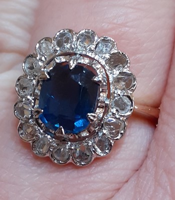 Lot 2074 - A Sapphire and Diamond Cluster Ring the oval...