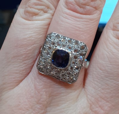 Lot 2075 - A Sapphire and Diamond Cluster Ring the square...