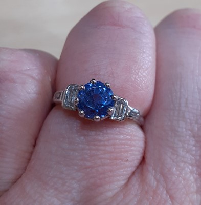 Lot 2137 - A Sapphire and Diamond Ring the round cut...