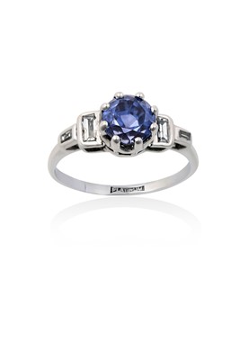 Lot 2137 - A Sapphire and Diamond Ring the round cut...