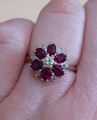 Lot 2100 - A Pinkish-Red Stone and Diamond Cluster Ring...