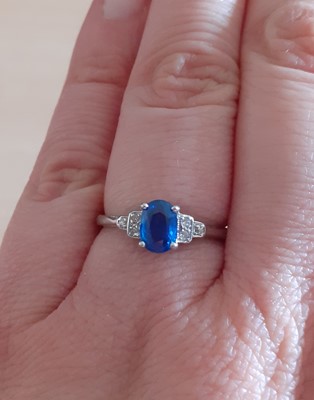 Lot 2070 - A Sapphire and Diamond Ring the oval cut...