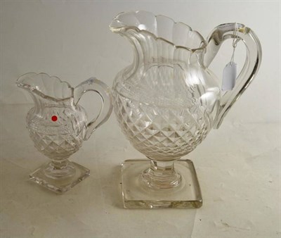 Lot 216 - Two cut glass jugs on square bases