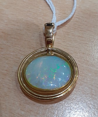 Lot 2007 - An Opal Pendant the oval opal plaque in a...