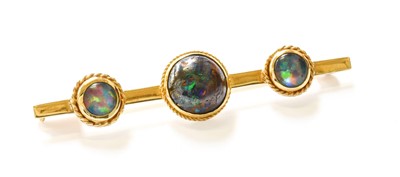 Lot 45 - An Opal and Opal Doublet Brooch, the graduated...