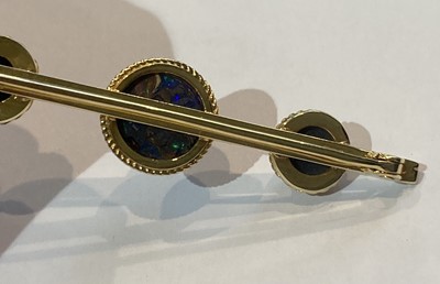 Lot 45 - An Opal and Opal Doublet Brooch, the graduated...