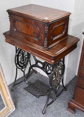 Lot 1324 - A Singer Treadle Sewing Machine, in walnut...