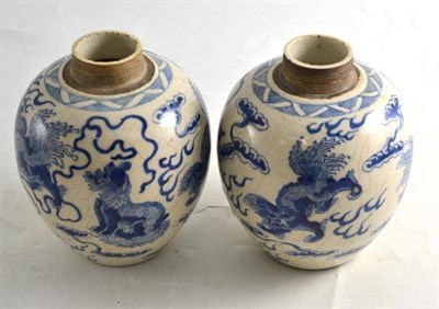 Lot 245 - A pair of blue and white ";soft paste"; ovoid jars, decorated with Buddhist lions and cloud...